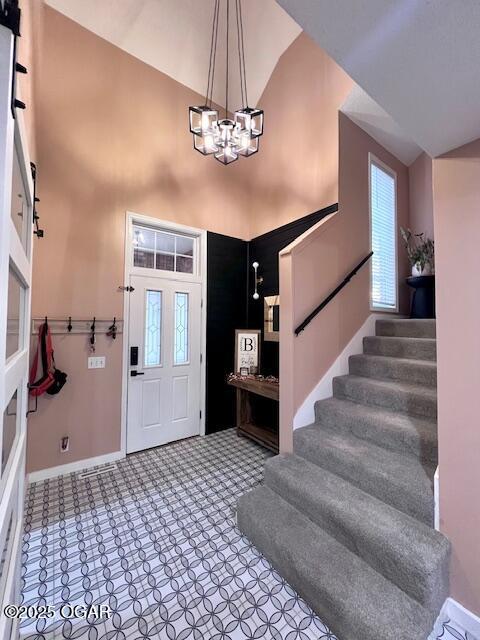 3331 Willow Ln, Joplin, MO 64801 - foyer entrance featuring high vaulted ceiling, baseboards, stairs, a chandelier, and healthy amount of natural light