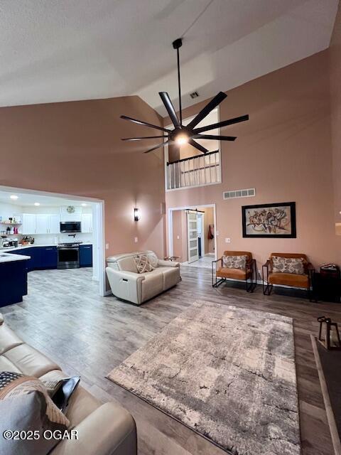 3331 Willow Ln, Joplin, MO 64801 - living area featuring ceiling fan, high vaulted ceiling, and wood finished floors