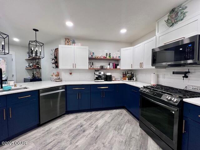 3331 Willow Ln, Joplin, MO 64801 - kitchen featuring stainless steel appliances, blue cabinetry, open shelves, tasteful backsplash, and recessed lighting