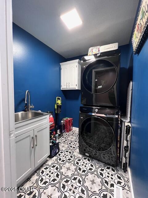 3331 Willow Ln, Joplin, MO 64801 - laundry area featuring stacked washer / dryer and cabinet space