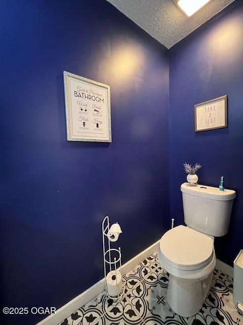 3331 Willow Ln, Joplin, MO 64801 - bathroom with a textured ceiling, toilet, and baseboards