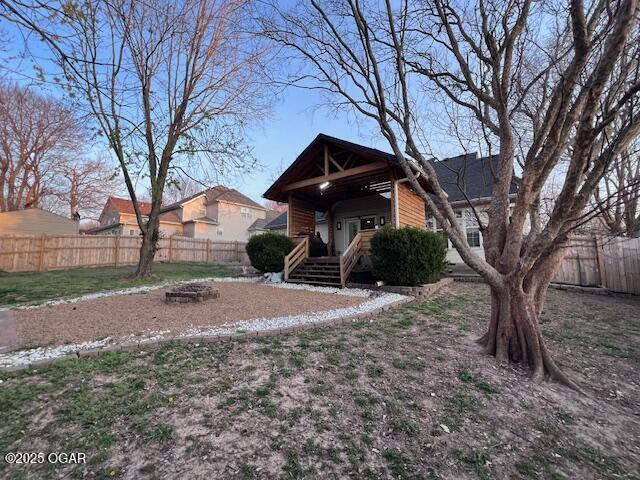 3331 Willow Ln, Joplin, MO 64801 - view of front facade featuring an outdoor fire pit and a fenced backyard