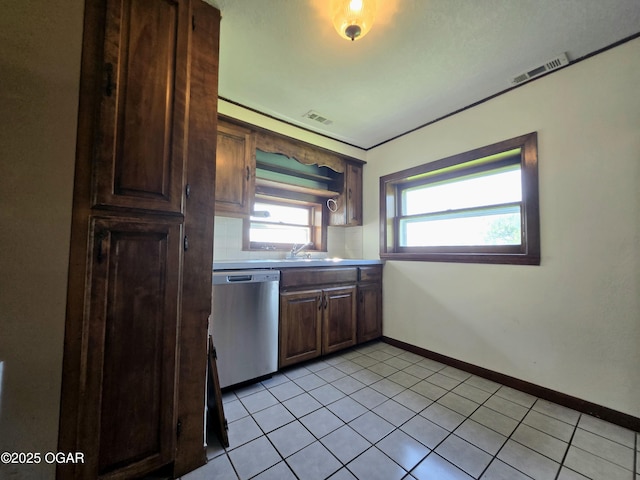 615 N Van Hoorebeke Rd, Joplin, MO 64801 - kitchen featuring stainless steel dishwasher, light tile patterned floors, baseboards, dark brown cabinets, and a sink
