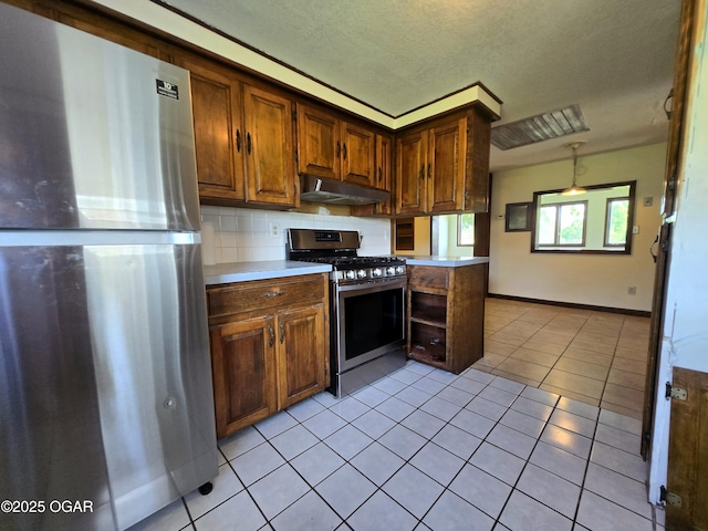 615 N Van Hoorebeke Rd, Joplin, MO 64801 - kitchen featuring appliances with stainless steel finishes, under cabinet range hood, light tile patterned floors, light countertops, and decorative backsplash