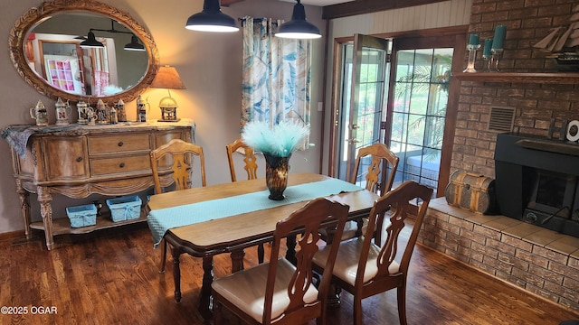 3002 S Main St, Galena, KS 66739 - dining room featuring wood finished floors and a brick fireplace
