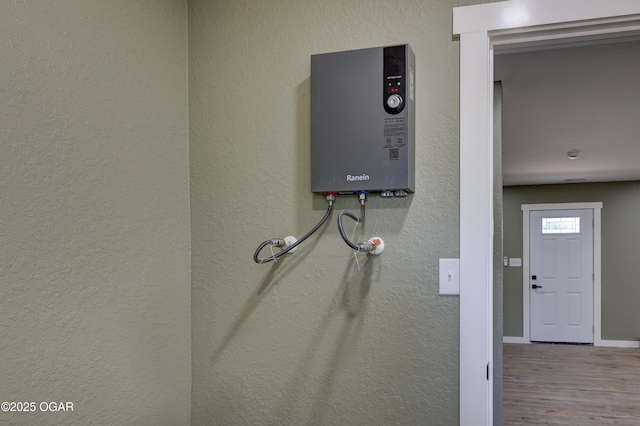 26204 King Ln, Carl Junction, MO 64834 - detailed view of wood finished floors, tankless water heater, and a textured wall
