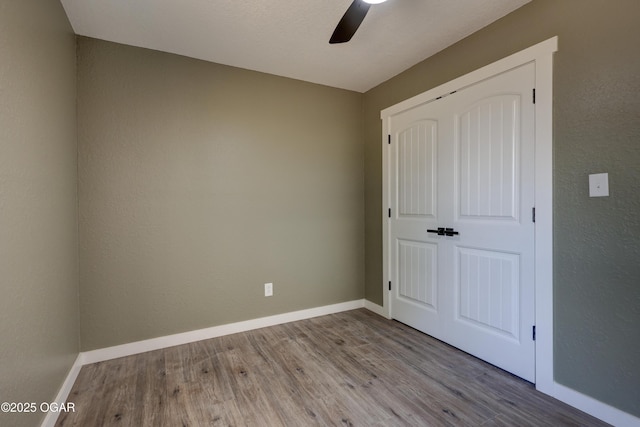 26204 King Ln, Carl Junction, MO 64834 - unfurnished bedroom featuring wood finished floors, a closet, and a ceiling fan