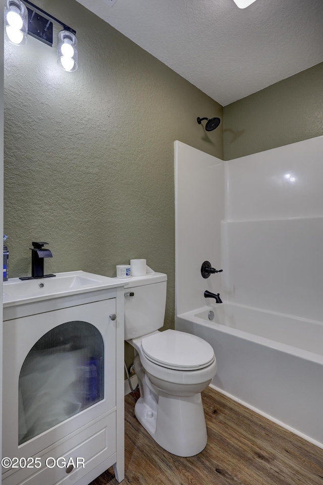 26204 King Ln, Carl Junction, MO 64834 - bathroom with wood finished floors, a textured wall, bathtub / shower combination, vanity, and a textured ceiling