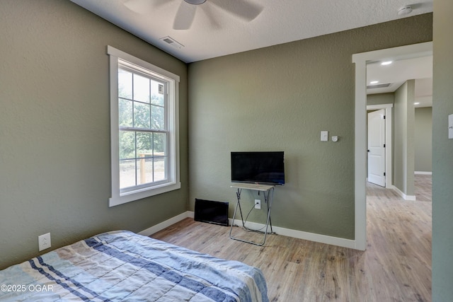 26204 King Ln, Carl Junction, MO 64834 - bedroom featuring wood finished floors, a textured wall, and ceiling fan