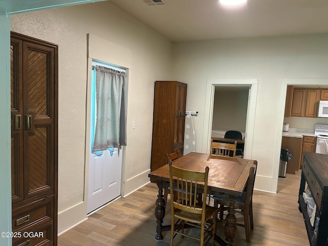 507 W Hill St, Neosho, MO 64850 - dining area with wood finished floors and a textured wall