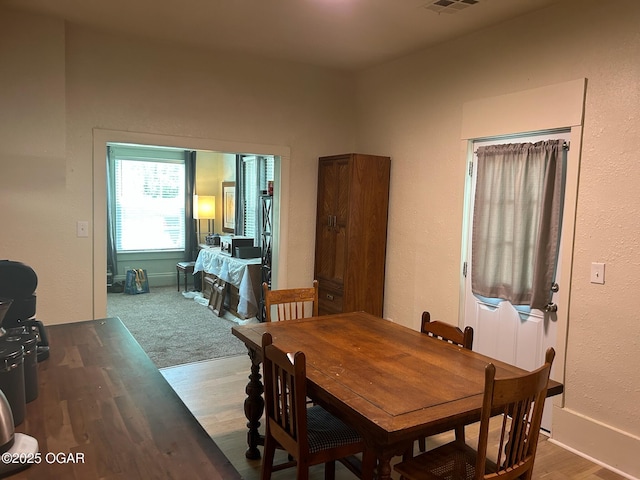 507 W Hill St, Neosho, MO 64850 - dining area with wood finished floors and a textured wall