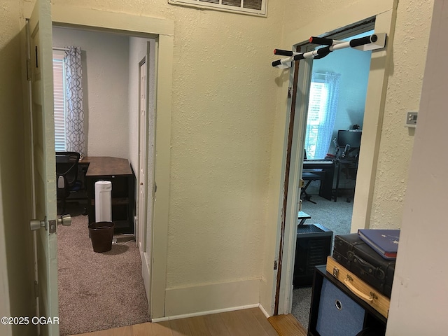 507 W Hill St, Neosho, MO 64850 - hallway featuring a textured wall, a desk, and wood finished floors