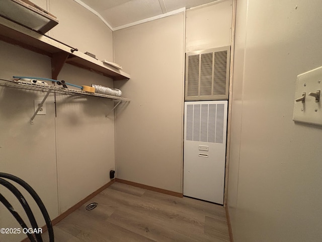 1346 SE Gum Ln, Baxter Springs, KS 66713 - laundry room with light wood-style flooring and a heating unit