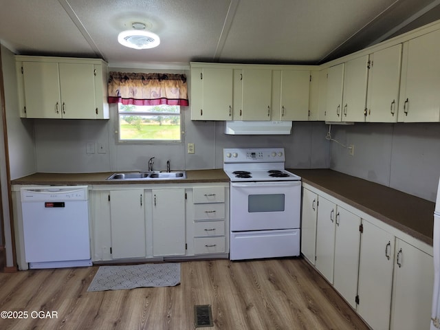 1346 SE Gum Ln, Baxter Springs, KS 66713 - kitchen with white appliances, under cabinet range hood, light wood-style flooring, dark countertops, and a textured ceiling