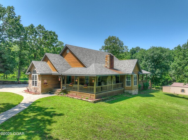 9404 County Lane 121, Carthage, MO 64836 - view of front facade with a porch, a shingled roof, a front yard, and stone siding