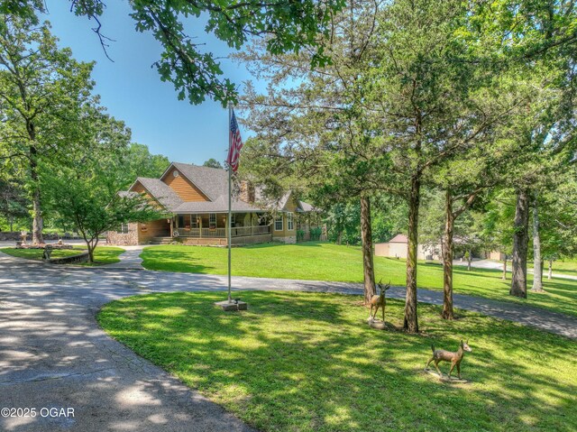9404 County Lane 121, Carthage, MO 64836 - view of front of property with a porch, a front lawn, and a shingled roof