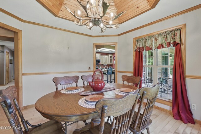 9404 County Lane 121, Carthage, MO 64836 - dining space featuring a chandelier, light wood-style flooring, and a raised ceiling