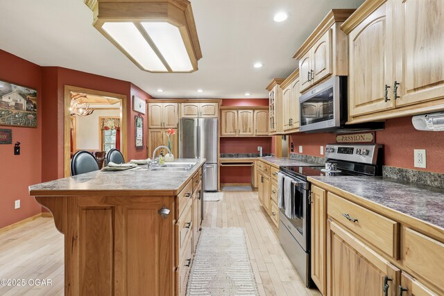 9404 County Lane 121, Carthage, MO 64836 - kitchen with stainless steel appliances, light wood-style floors, a kitchen island with sink, light brown cabinetry, and recessed lighting