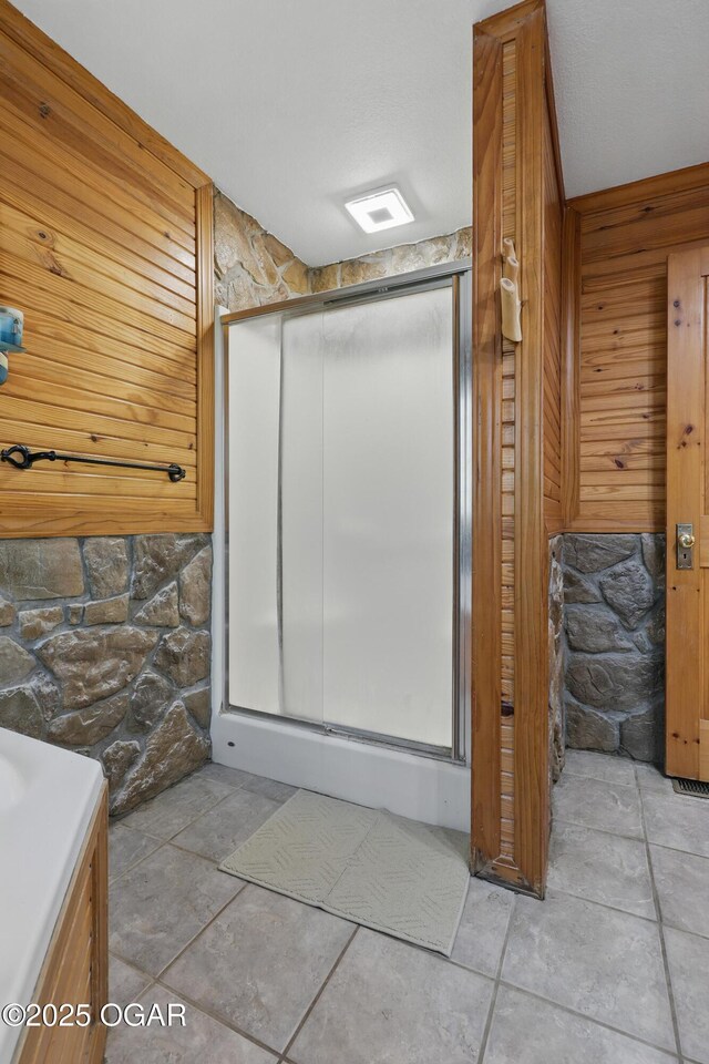 9404 County Lane 121, Carthage, MO 64836 - full bath featuring a stall shower, wood walls, vanity, and tile patterned floors