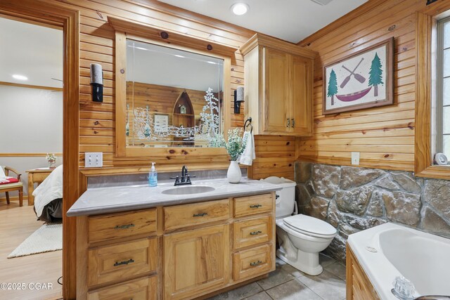 9404 County Lane 121, Carthage, MO 64836 - bathroom with vanity, a tub to relax in, and wooden walls