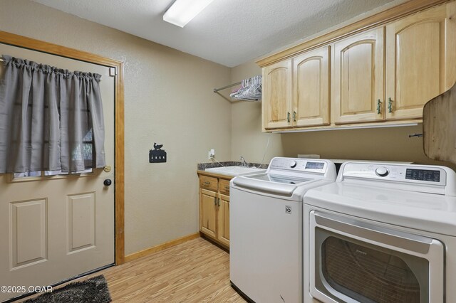 9404 County Lane 121, Carthage, MO 64836 - laundry area with washer and clothes dryer, light wood-style flooring, cabinet space, and a textured ceiling