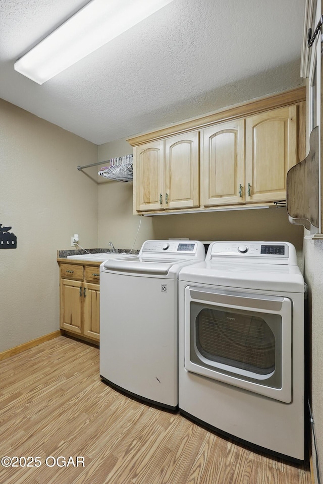 9404 County Lane 121, Carthage, MO 64836 - laundry room featuring cabinet space, washer and clothes dryer, and light wood finished floors