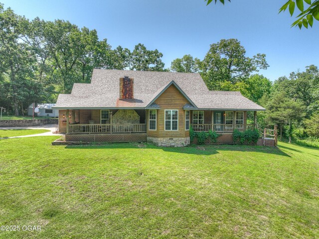 9404 County Lane 121, Carthage, MO 64836 - log home featuring covered porch, a front yard, a chimney, and a shingled roof