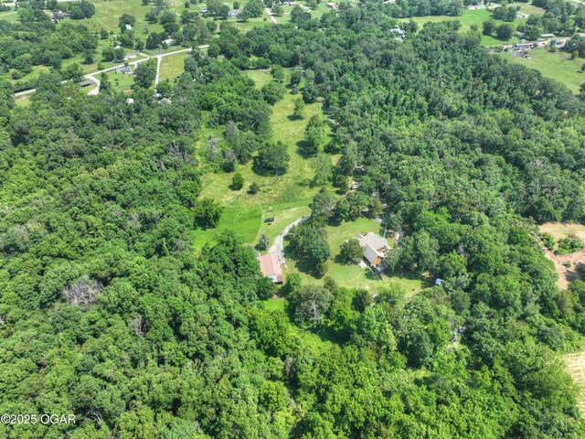 9404 County Lane 121, Carthage, MO 64836 - aerial view of property and surrounding area with a heavily wooded area