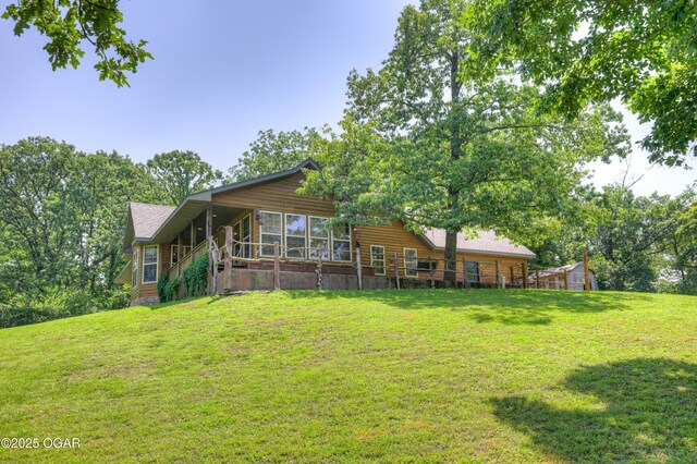 9404 County Lane 121, Carthage, MO 64836 - back of property featuring a lawn and a sunroom