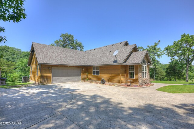 9404 County Lane 121, Carthage, MO 64836 - view of front of house with driveway, a garage, and a shingled roof