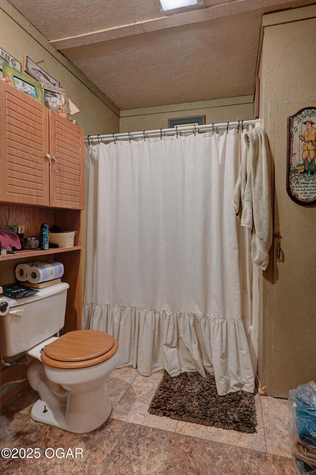 9404 County Lane 121, Carthage, MO 64836 - full bathroom featuring stone finish floors, a textured wall, a shower with shower curtain, and a textured ceiling