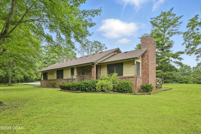 5694 Spurgeon Rd, Joplin, MO 64804 - view of front facade with brick siding, a front lawn, a chimney, and roof with shingles