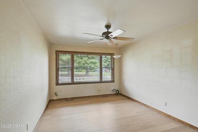 5694 Spurgeon Rd, Joplin, MO 64804 - empty room with light wood-style floors and ceiling fan