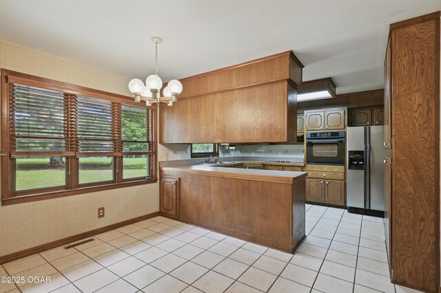 5694 Spurgeon Rd, Joplin, MO 64804 - kitchen featuring black oven, stainless steel refrigerator with ice dispenser, a peninsula, a chandelier, and light tile patterned floors