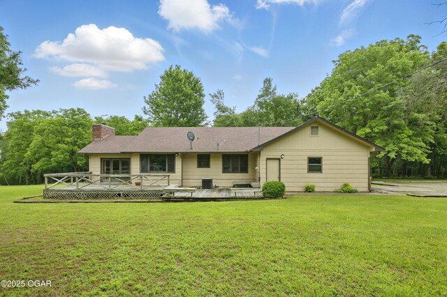 5694 Spurgeon Rd, Joplin, MO 64804 - back of property with a chimney, a yard, and a deck