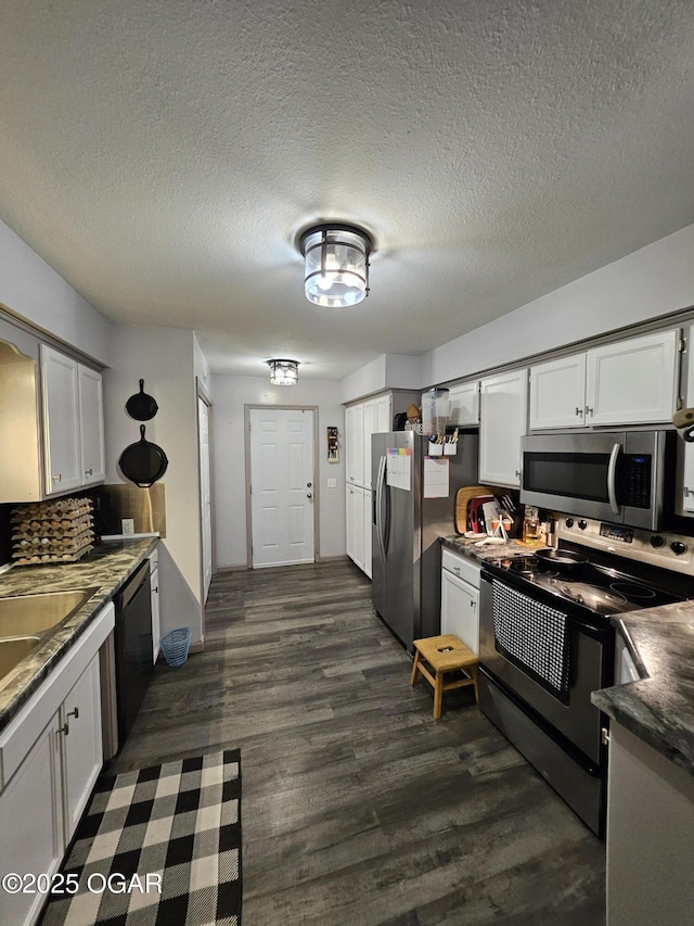 5358 Lawrence Unit 2220, Pierce City, MO 65723 - kitchen with appliances with stainless steel finishes, dark countertops, white cabinetry, dark wood-type flooring, and a textured ceiling