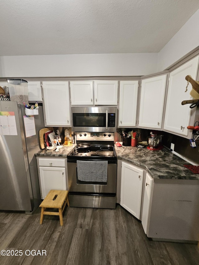 5358 Lawrence Unit 2220, Pierce City, MO 65723 - kitchen featuring appliances with stainless steel finishes, dark wood-style floors, and white cabinets