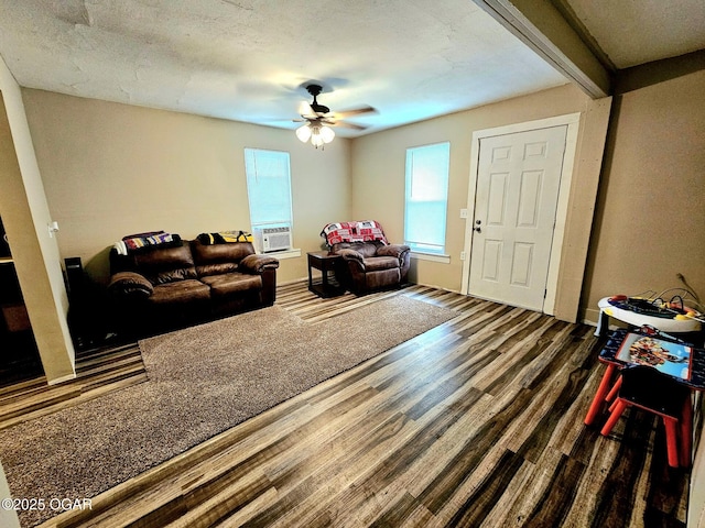 1109 Lincoln Ave, Baxter Springs, KS 66713 - living area featuring wood finished floors, ceiling fan, beam ceiling, and cooling unit