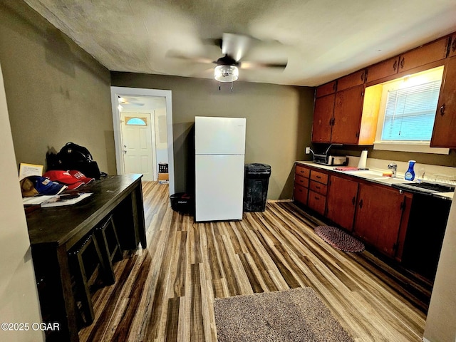 1109 Lincoln Ave, Baxter Springs, KS 66713 - kitchen with freestanding refrigerator, a ceiling fan, and light wood finished floors