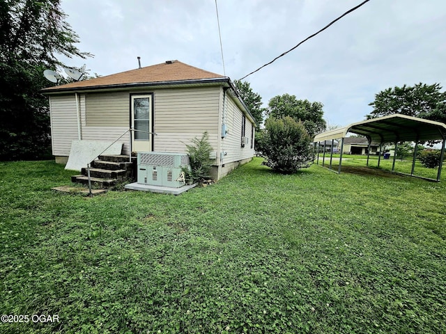 1109 Lincoln Ave, Baxter Springs, KS 66713 - rear view of property with a detached carport and a lawn