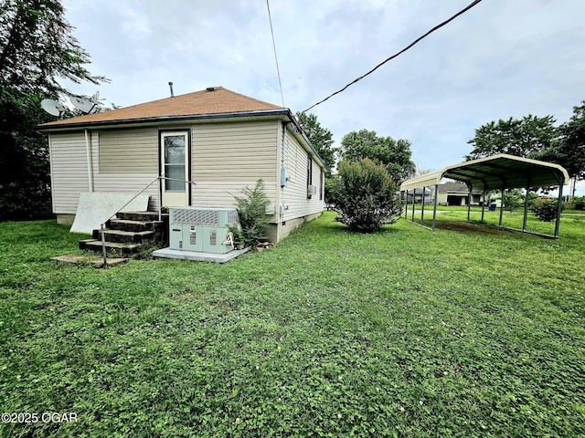 1109 Lincoln Ave, Baxter Springs, KS 66713 - back of property featuring a carport and a yard
