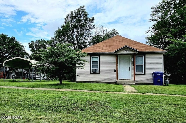 1109 Lincoln Ave, Baxter Springs, KS 66713 - view of front of property with a detached carport and a front yard