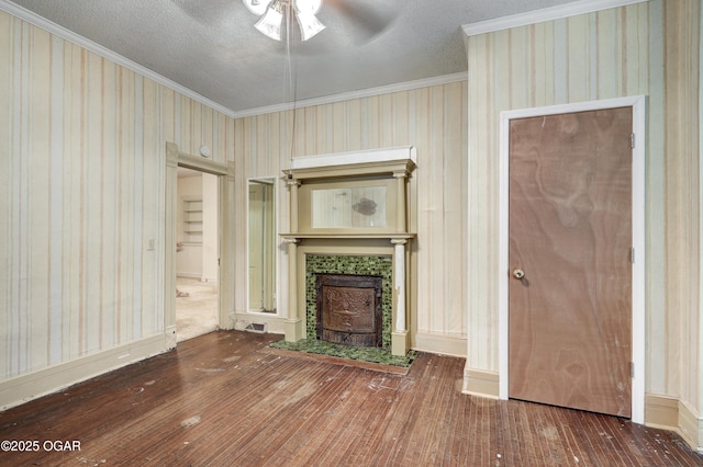 117 S 11th St, Sarcoxie, MO 64862 - unfurnished living room featuring wood-type flooring, a ceiling fan, ornamental molding, a tile fireplace, and wallpapered walls