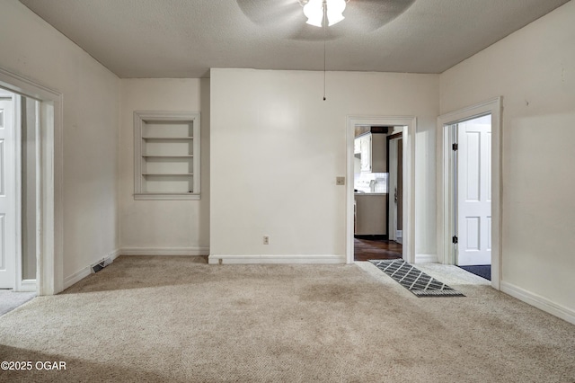 117 S 11th St, Sarcoxie, MO 64862 - carpeted spare room featuring a ceiling fan, a textured ceiling, and built in features