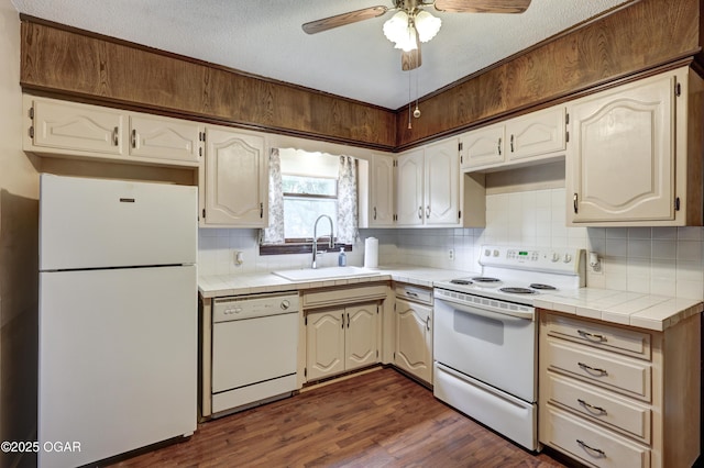 117 S 11th St, Sarcoxie, MO 64862 - kitchen featuring white appliances, tile counters, dark wood finished floors, decorative backsplash, and a ceiling fan