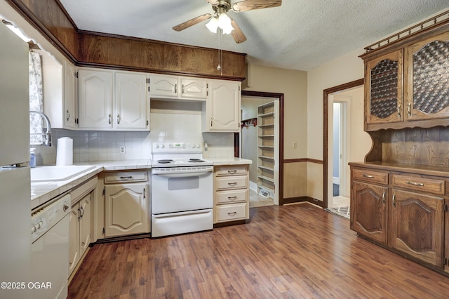 117 S 11th St, Sarcoxie, MO 64862 - kitchen with white appliances, ceiling fan, dark wood finished floors, decorative backsplash, and tile counters