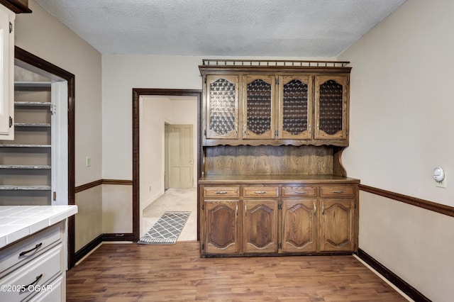 117 S 11th St, Sarcoxie, MO 64862 - interior space with wood finished floors and a textured ceiling