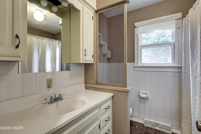 117 S 11th St, Sarcoxie, MO 64862 - full bath featuring tile walls, vanity, and a wainscoted wall