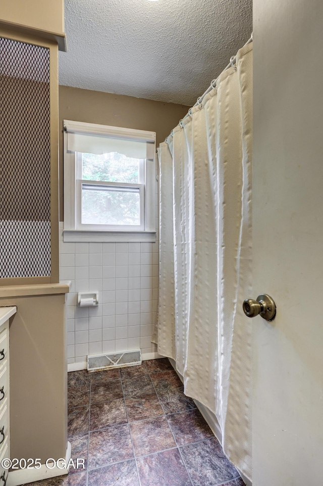 117 S 11th St, Sarcoxie, MO 64862 - full bath with tile walls, vanity, and a textured ceiling