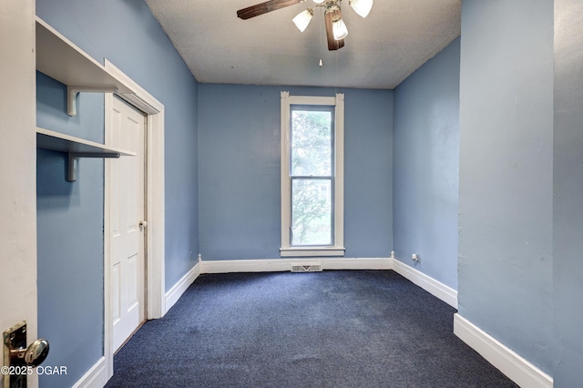 117 S 11th St, Sarcoxie, MO 64862 - unfurnished bedroom featuring dark colored carpet, ceiling fan, and a textured ceiling